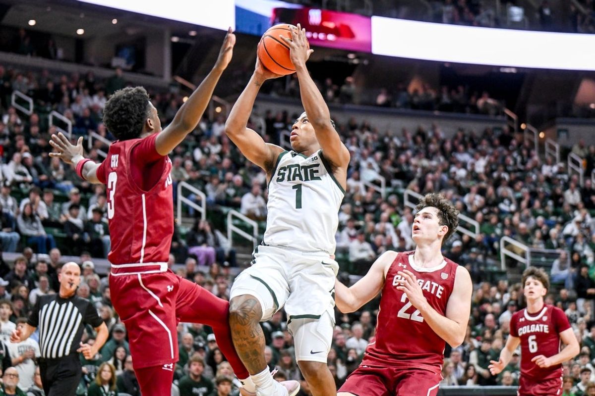 Michigan State's Jeremy Fears Jr., center, scores between Colgate's Jalen Cox, left, and Andrew Alekseyenko during the first half on Monday, Nov. 3, 2025, at the Breslin Center in East Lansing.