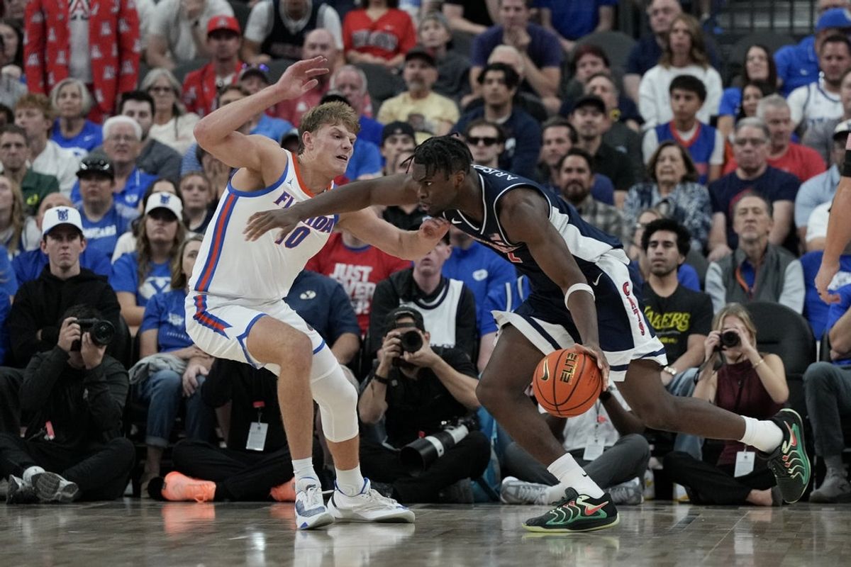 Nov 3, 2025; Las Vegas, NV, USA; Florida Gators forward Thomas Haugh (10) defends Arizona Wildcats guard Dwayne Aristode (2) in the first half of the Hall of Fame Series game at T-Mobile Arena. Mandatory Credit: Candice Ward-Imagn Images