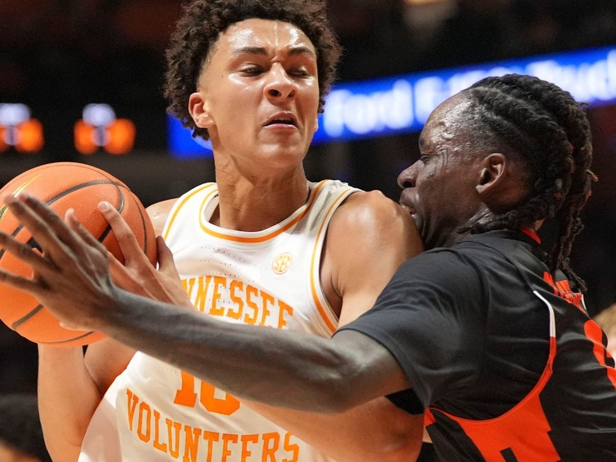 Tennessee forward Nate Ament (10) tries to move the ball while guarded by Mercer guard Baraka Okojie (6) during an NCAA college basketball game on November 3, 2025, in Knoxville, Tenn.