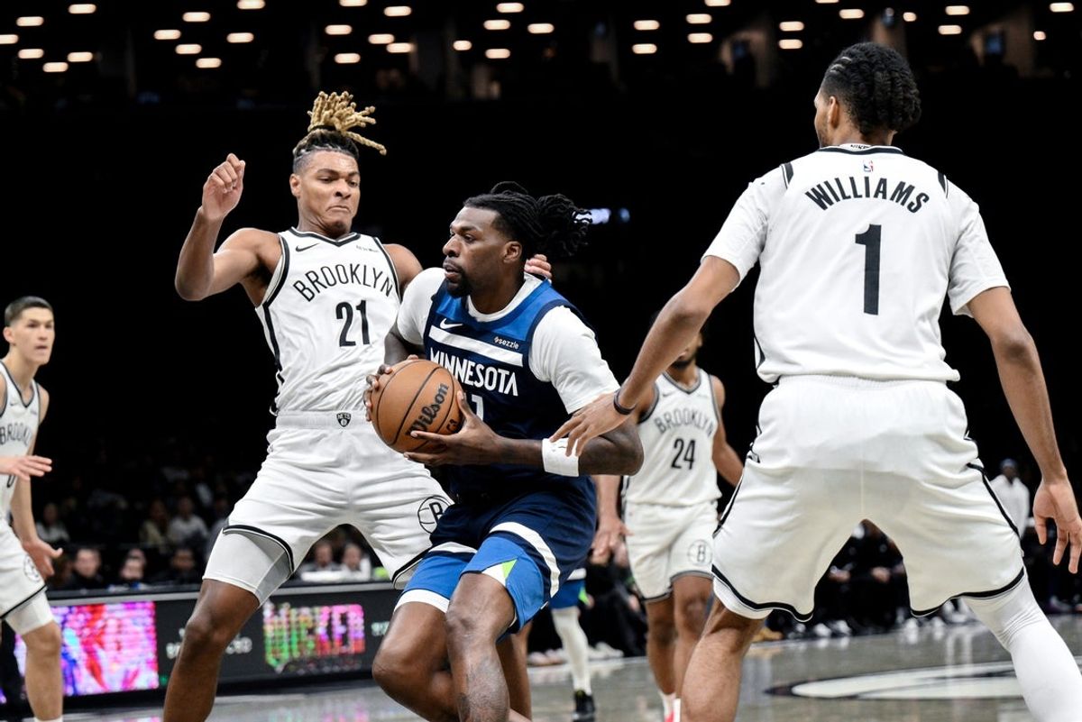 Nov 3, 2025; Brooklyn, New York, USA; Minnesota Timberwolves center Naz Reid (11) drives to the basket while defended by Brooklyn Nets forward Noah Clowney (21) and forward Ziaire Williams (1) during the first half at Barclays Center. Mandatory Credit: John Jones-Imagn Images