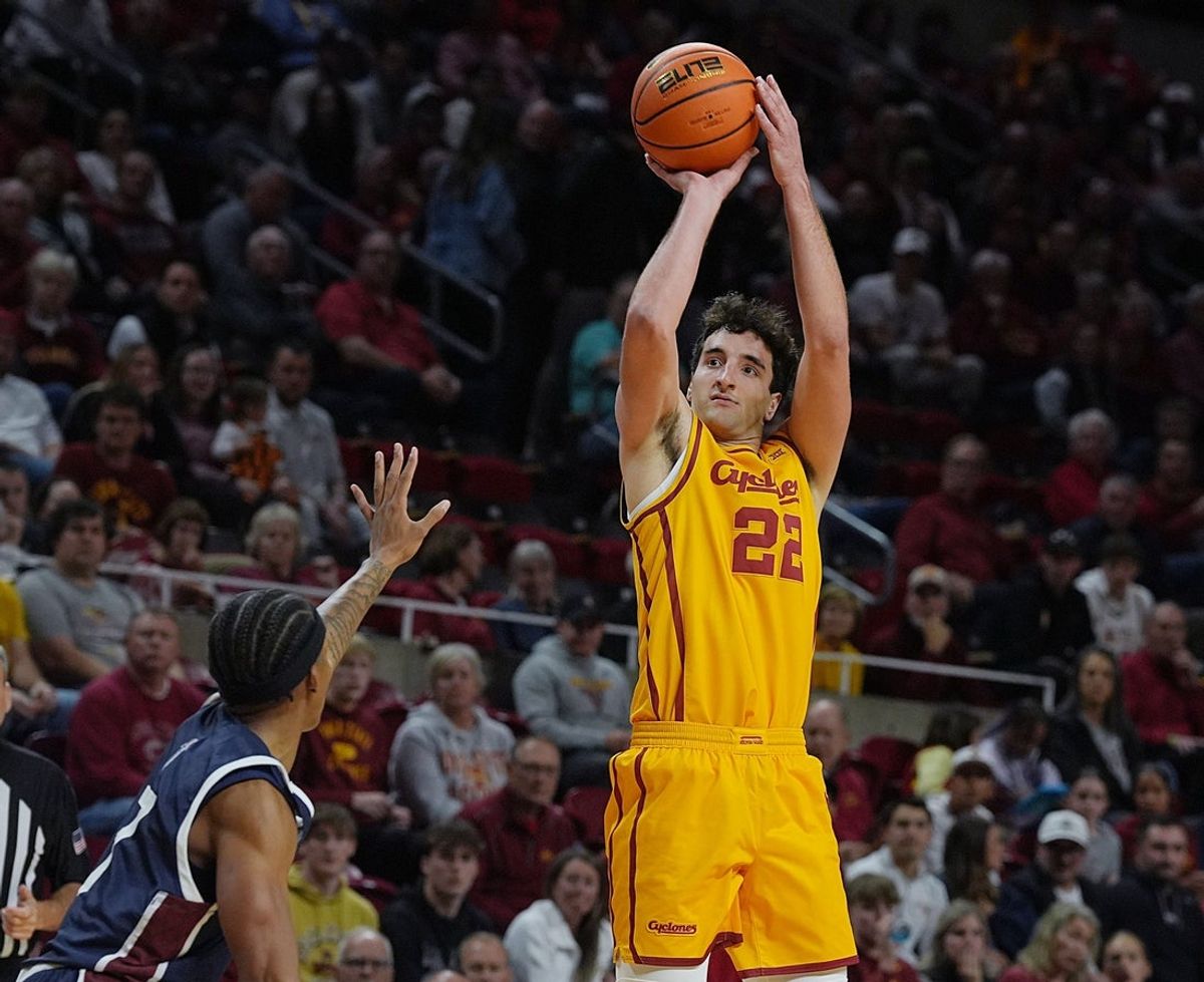 Iowa State Cyclones forward Milan Momcilovic (22) takes a three-point shot around FDU Knights guard guard Eric Parnell (7) during the first half of the season-opener on Nov. 3, 2025, at Hilton Coliseum in Ames.
