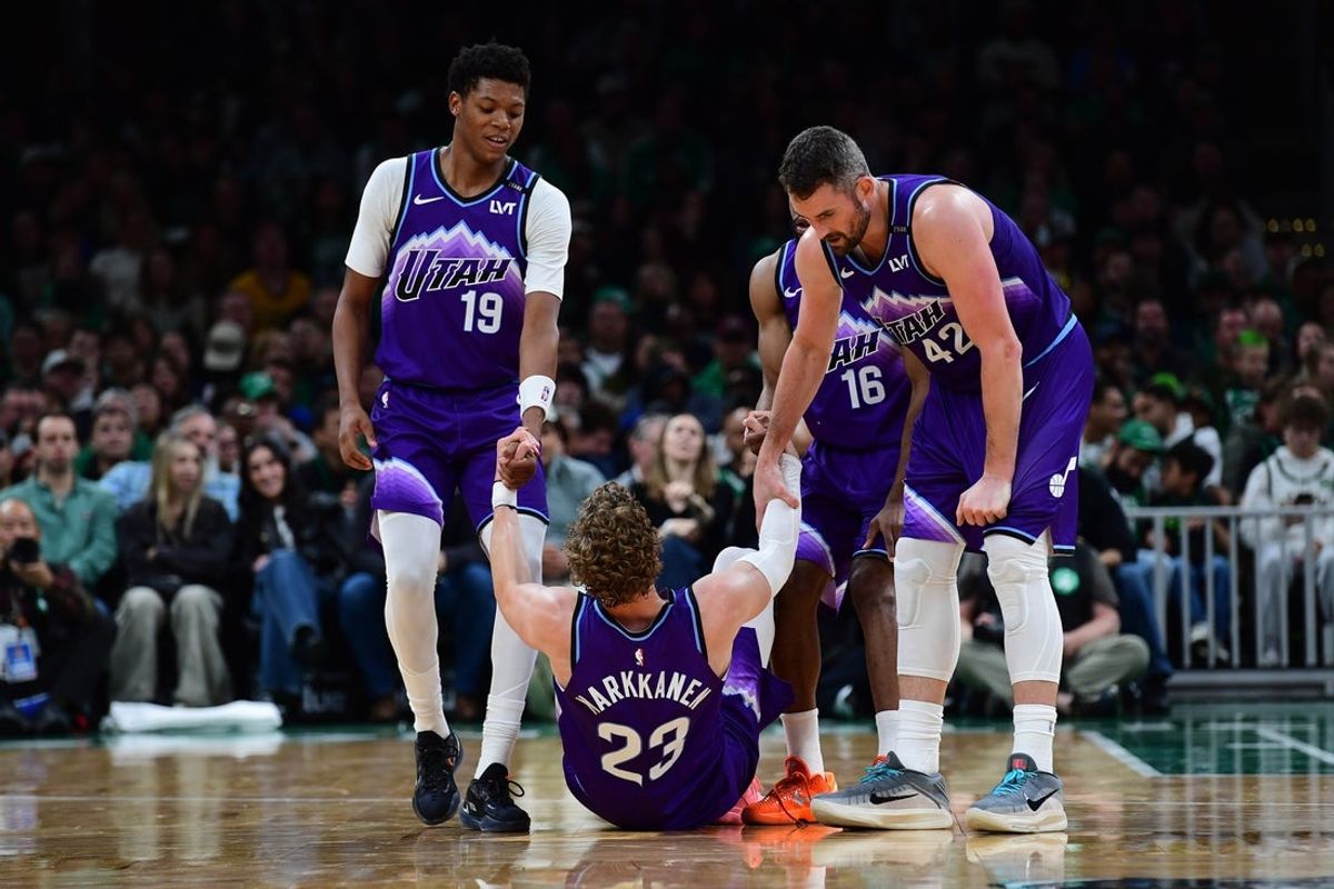 Nov 3, 2025; Boston, Massachusetts, USA; Utah Jazz guard Ace Bailey (19) and forward Kevin Love (42) help forward Lauri Markkanen (23) during the first half against the Boston Celtics at TD Garden. Mandatory Credit: Bob DeChiara-Imagn Images