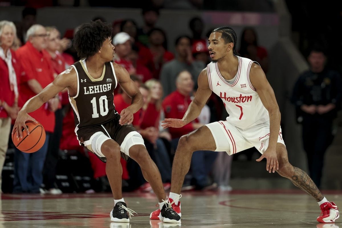 Nov 3, 2025; Houston, Texas, USA; Houston Cougars guard Milos Uzan (7) defends against Lehigh Mountain Hawks guard Caleb Thomas (10) during the first half at Fertitta Center. Mandatory Credit: Maria Lysaker-Imagn Images
