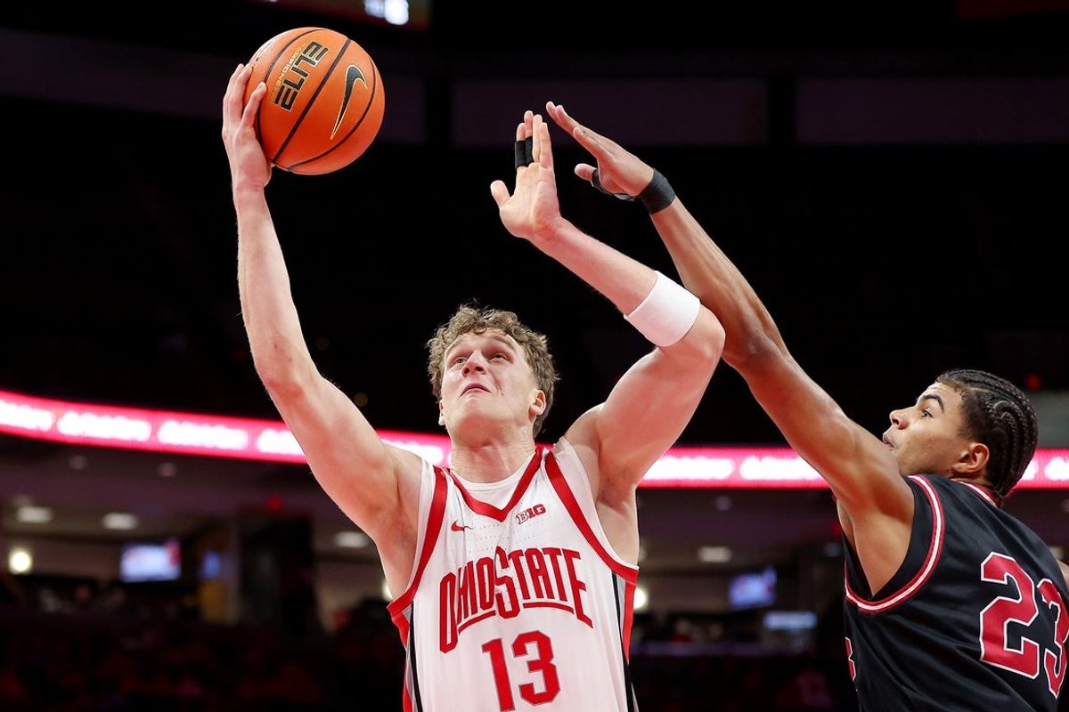 Nov 3, 2025; Columbus, Ohio, USA;  Ohio State Buckeyes center Christoph Tilly (13) drives to the basket as IU Indy Jaguars forward Aiden Miller (23) defends during the second half at Value City Arena. Mandatory Credit: Joseph Maiorana-Imagn Images