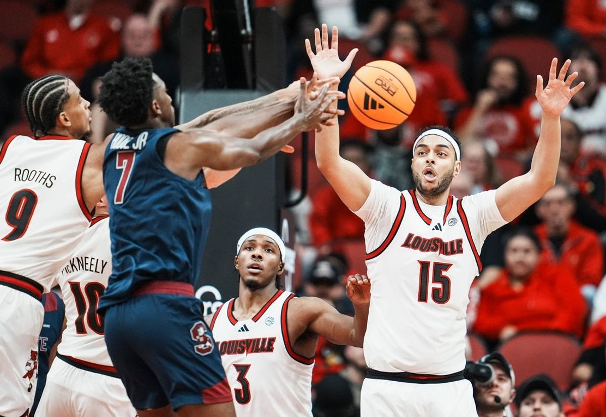 Louisville Cardinals forward Khani Rooths (9) tussles with South Carolina State Bulldogs guard Derwin Hodge (7) for a loose ball as Louisville Cardinals guard Ryan Conwell (3) and Louisville Cardinals center Aly Khalifa (15) watch at the KFC Yum! Center Monday night, Nov. 3, 2025.