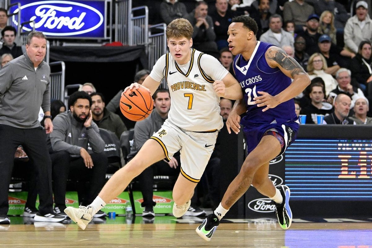 Nov 3, 2025; Providence, Rhode Island, USA; Providence Friars guard Stefan Vaaks (7) drives to the basket against Holy Cross Crusaders guard Gabe Warren (21) during the first half at Amica Mutual Pavilion. Mandatory Credit: Eric Canha-Imagn Images