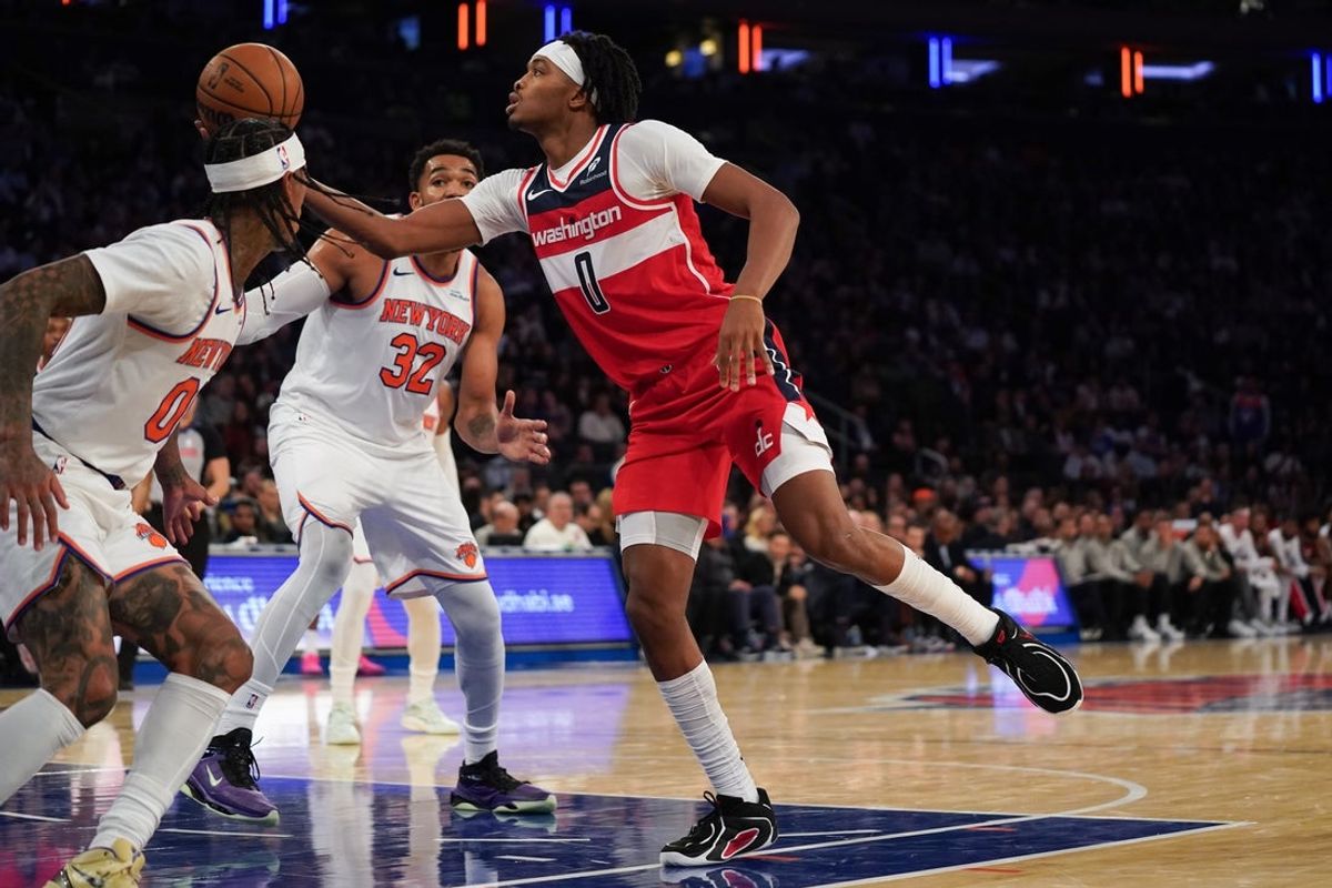 Nov 3, 2025; New York, New York, USA; Washington guard Bilal Coulibaly (0) drives on New York Knicks guard Jordan Clarkson (00) during the second half at Madison Square Garden. Mandatory Credit: Lucas Boland-Imagn Images