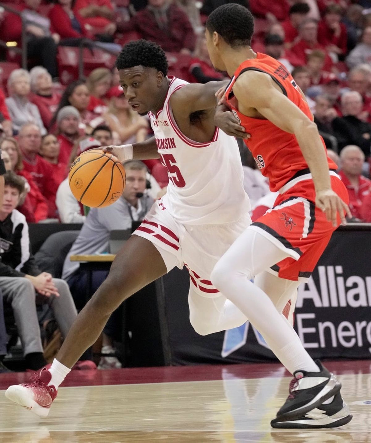 Wisconsin guard John Blackwell (25) turns the corner on Campbell guard Cam Gregory (7) during the second half of their game Monday, November 3, 2025 at the Kohl Center in Madison, Wisconsin.