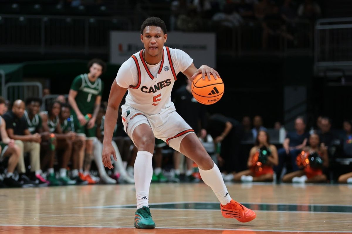 Nov 3, 2025; Coral Gables, Florida, USA; Miami Hurricanes forward Malik Reneau (5) dribbles the basketball against the Jacksonville Dolphins during the second half at Watsco Center. Mandatory Credit: Sam Navarro-Imagn Images