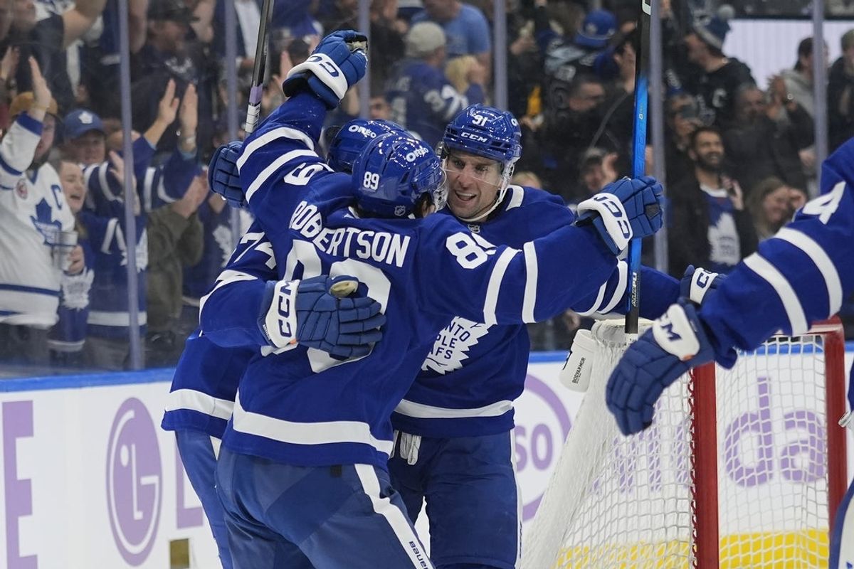 Nov 3, 2025; Toronto, Ontario, CAN;Toronto Maple Leafs forward John Tavares (91) and forward Nic Robertson (89) congratulate forward Bobby McMann (74) on his game winning goal against the Pittsburgh Penguins during the third period at Scotiabank Arena. Mandatory Credit: John E. Sokolowski-Imagn Images