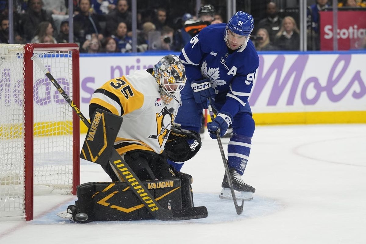 Nov 3, 2025; Toronto, Ontario, CAN; Pittsburgh Penguins goaltender Tristan Jarry (35) makes a save against Toronto Maple Leafs forward John Tavares (91) during the first period at Scotiabank Arena. Mandatory Credit: John E. Sokolowski-Imagn Images