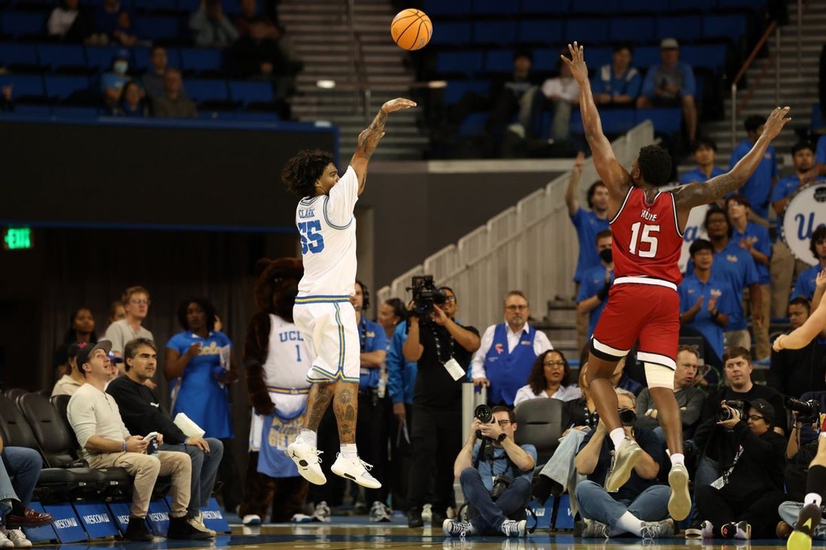 Nov 3, 2025; Los Angeles, California, USA;  UCLA Bruins guard Skyy Clark (55) shoots three point basket over Eastern Washington Eagles forward Kiree Huie (15) during the first half at Pauley Pavilion presented by Wescom Financial. Mandatory Credit: Kiyoshi Mio-Imagn Images