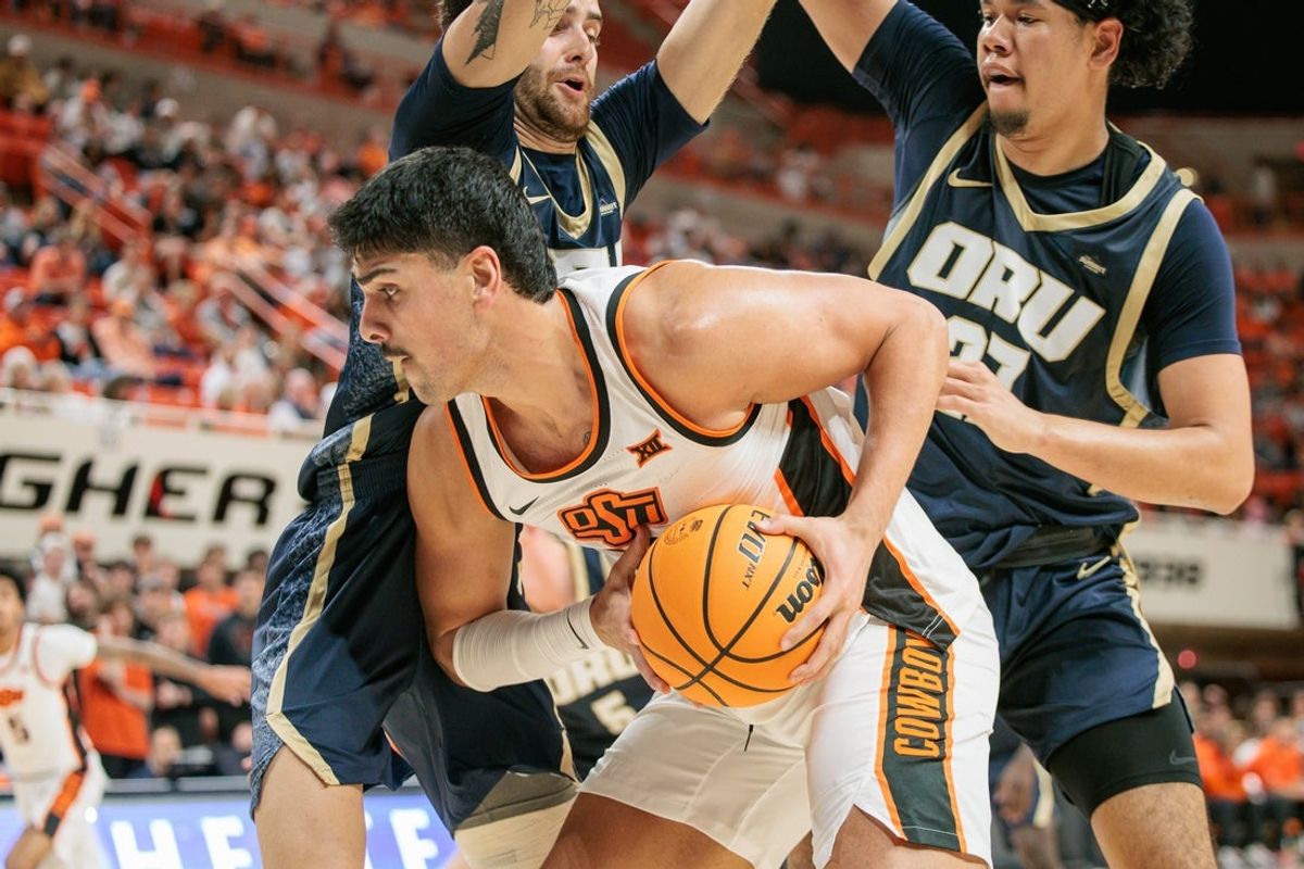 Nov 4, 2025; Stillwater, Oklahoma, USA; Oklahoma State Cowboys center Parsa Fallah (22) drives to the basket during the first half against the Oral Roberts Golden Eagles at Gallagher-Iba Arena. Mandatory Credit: William Purnell-Imagn Images