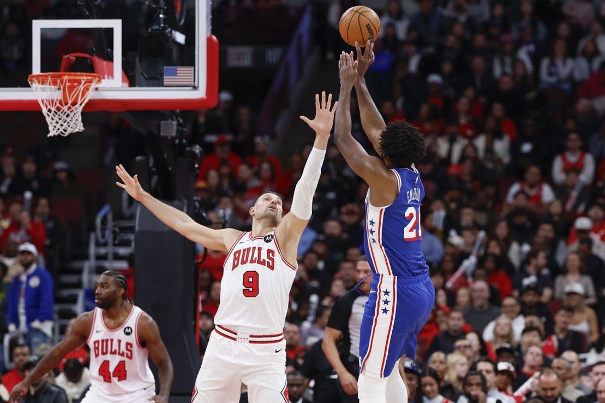 Nov 4, 2025; Chicago, Illinois, USA; Philadelphia 76ers center Joel Embiid (21) shoots against Chicago Bulls center Nikola Vucevic (9) during the first half at United Center. Mandatory Credit: Kamil Krzaczynski-Imagn Images
