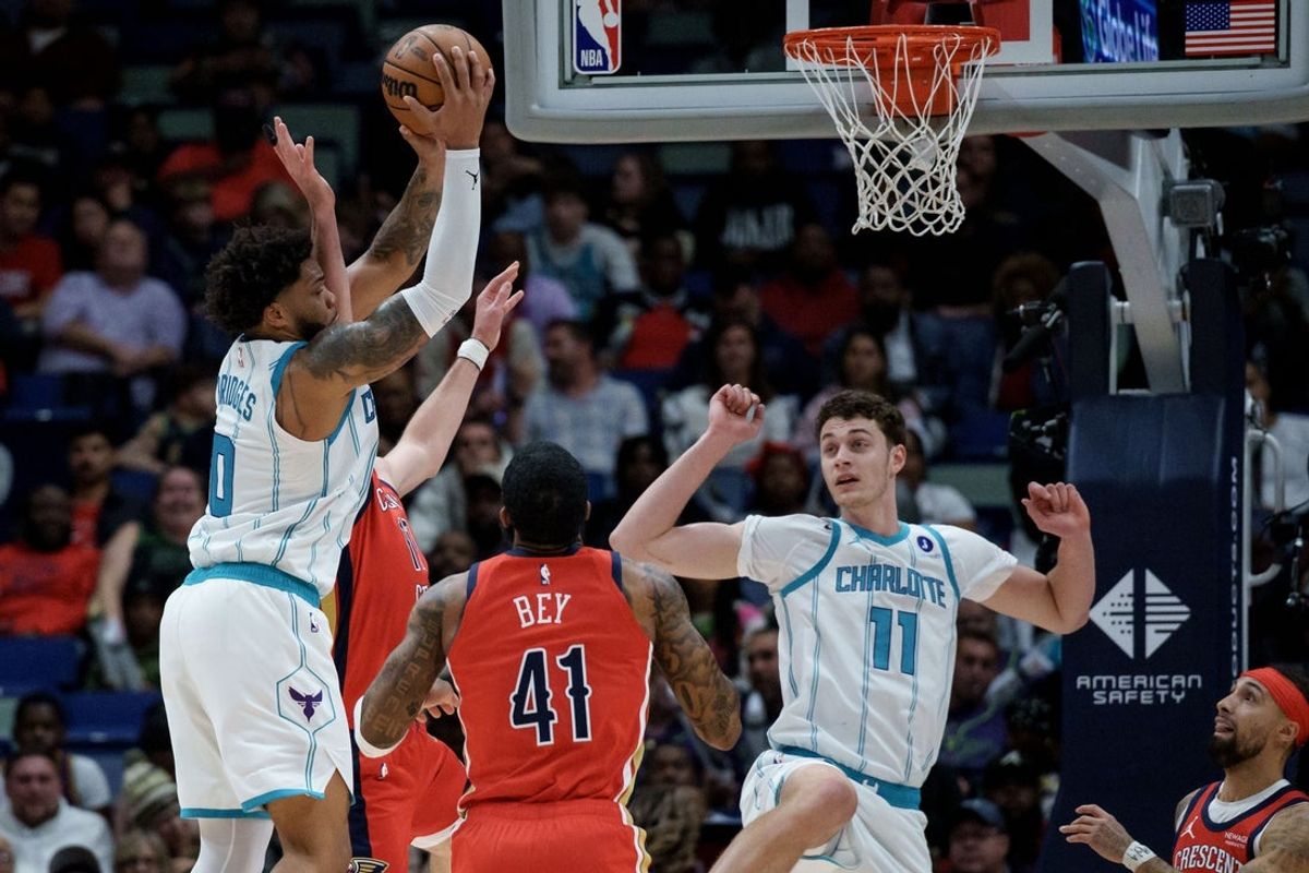 Nov 4, 2025; New Orleans, Louisiana, USA;  Charlotte Hornets forward Miles Bridges (0) shoots against New Orleans Pelicans forward Karlo Matkovic (17) during the first half at Smoothie King Center. Mandatory Credit: Matthew Hinton-Imagn Images