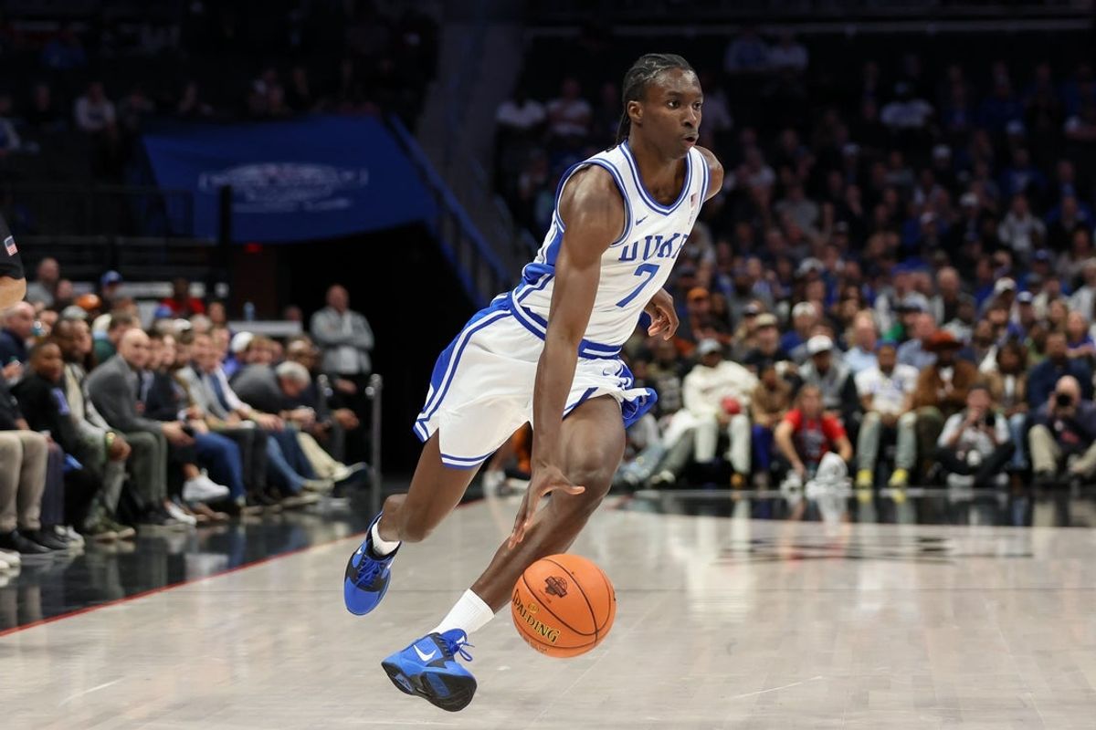 Nov 4, 2025; Charlotte, North Carolina, USA; Duke Blue Devils guard Dame Sarr (7) drives the ball against the Texas Longhorns during the first half of the Dick Vitale’s Invitational game at Spectrum Center. Mandatory Credit: Cory Knowlton-Imagn Images