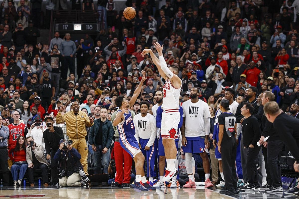 Nov 4, 2025; Chicago, Illinois, USA; Chicago Bulls center Nikola Vucevic (9) shoots and scores a game winning three-pointer against Philadelphia 76ers guard Quentin Grimes (5) during the second half at United Center. Mandatory Credit: Kamil Krzaczynski-Imagn Images