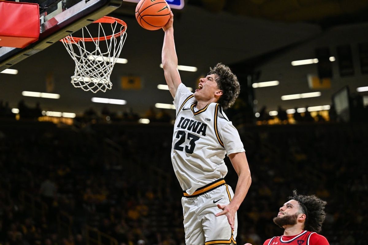 Nov 4, 2025; Iowa City, Iowa, USA; Iowa Hawkeyes guard Isaia Howard (23) completes a slam dunk against the Robert Morris Colonials during the second half at Carver-Hawkeye Arena. Mandatory Credit: Jeffrey Becker-Imagn Images