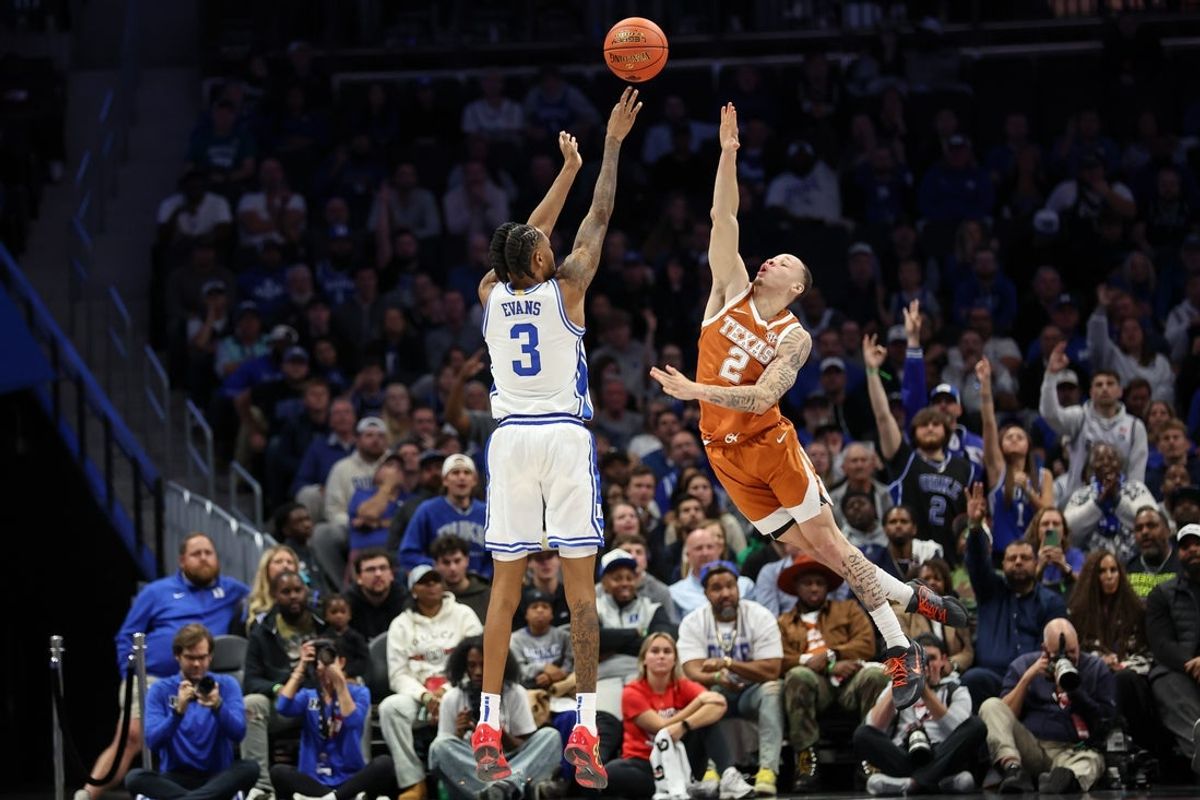 Nov 4, 2025; Charlotte, North Carolina, USA; Duke Blue Devils guard Isaiah Evans (3) makes a jump while Texas Longhorns guard Chendall Weaver (2) attempts to block during the second half of the Dick Vitale’s Invitational game at Spectrum Center. Mandatory Credit: Cory Knowlton-Imagn Images