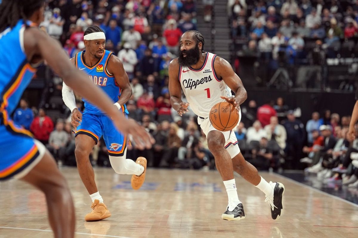 Nov 4, 2025; Inglewood, California, USA; LA Clippers guard James Harden (1) dribbles the ball against Oklahoma City Thunder guard Shai Gilgeous-Alexander (2) in the first half at Intuit Dome. Mandatory Credit: Kirby Lee-Imagn Images