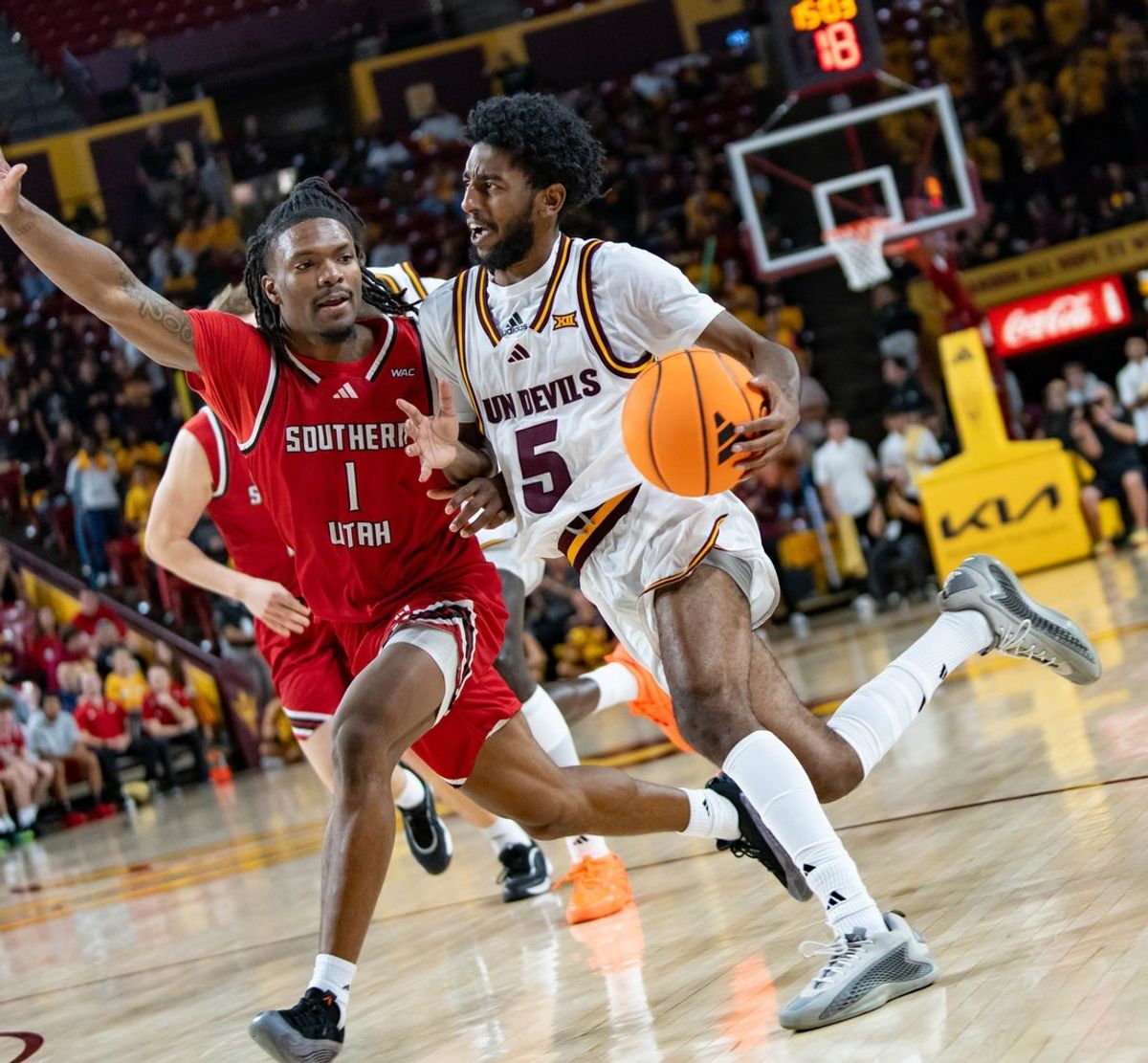 Arizona State Sun Devils Moe Odum (5) runs with the ball against Southern Utah Thunderbirds Elijah Duval (1) during a game at Desert Financial Arena in Tempe on Nov. 4, 2025.