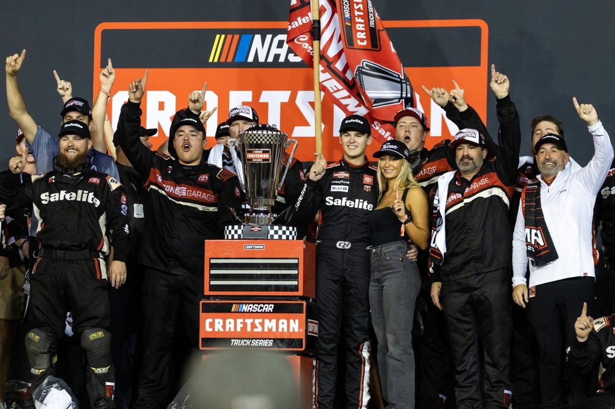 Oct 31, 2025; Avondale, Arizona, USA; NASCAR Truck Series driver Corey Heim (11) celebrates with girlfriend Taylor Reimer after winning the NASCAR Truck Series Championship race and the 2025 Truck Series championship at Phoenix Raceway. Mandatory Credit: Mark J. Rebilas-Imagn Images