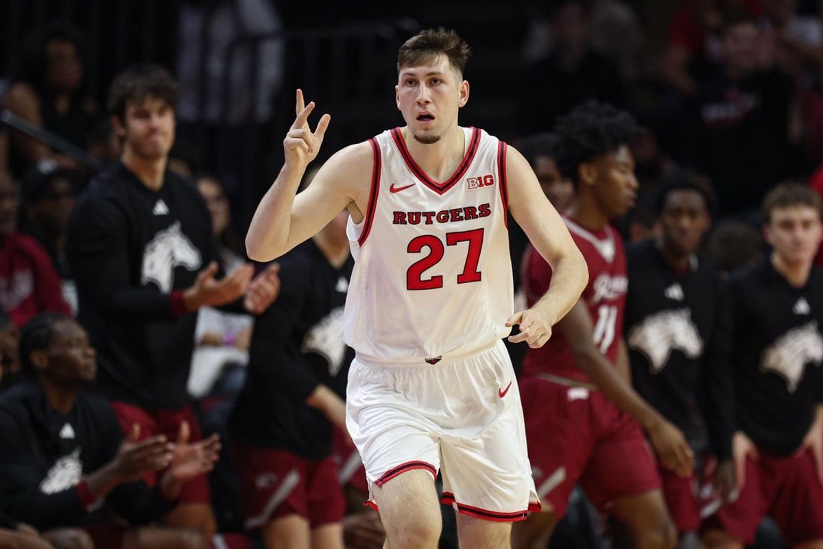 Nov 5, 2025; Piscataway, New Jersey, USA; Rutgers Scarlet Knights forward Denis Badalau (27) reacts after making a three point basket during the first half against the Rider Broncs at Jersey Mike's Arena. Mandatory Credit: Vincent Carchietta-Imagn Images