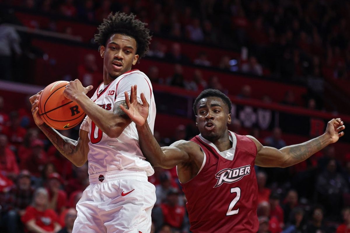 Nov 5, 2025; Piscataway, New Jersey, USA; Rutgers Scarlet Knights guard Tariq Francis (0) rebounds against Rider Broncs guard Caleb Smith (2) during the first half at Jersey Mike's Arena. Mandatory Credit: Vincent Carchietta-Imagn Images