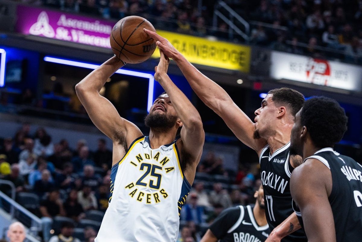Nov 5, 2025; Indianapolis, Indiana, USA; Indiana Pacers forward Jeremiah Robinson-Earl (25) shoots the ball while Brooklyn Nets forward Michael Porter Jr. (17) defends in the first half  at Gainbridge Fieldhouse. Mandatory Credit: Trevor Ruszkowski-Imagn Images