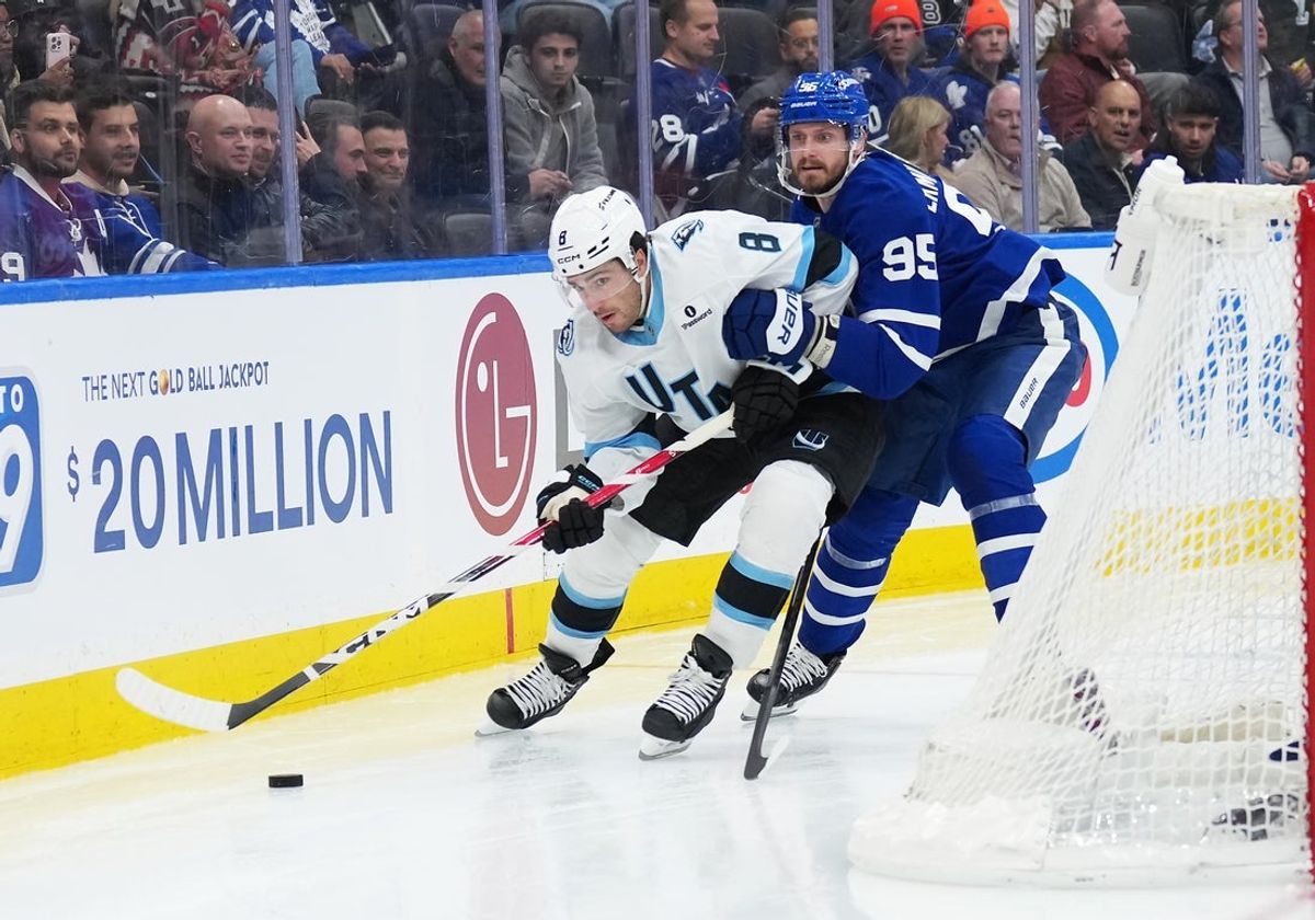 Nov 5, 2025; Toronto, Ontario, CAN; Utah Mammoth center Nick Schmaltz (8) battles for the puck with Toronto Maple Leafs defenseman Oliver Ekman-Larsson (95) during the second period at Scotiabank Arena. Mandatory Credit: Nick Turchiaro-Imagn Images