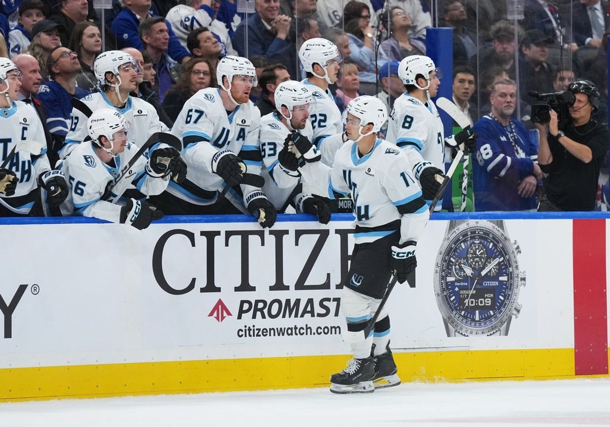 Nov 5, 2025; Toronto, Ontario, CAN; Utah Mammoth right wing Dylan Guenther (11) celebrates at the bench after scoring a goal against the Toronto Maple Leafs during the third period at Scotiabank Arena. Mandatory Credit: Nick Turchiaro-Imagn Images