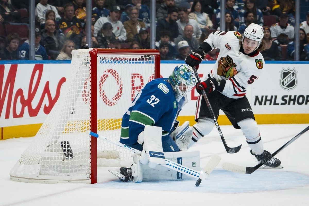 Nov 5, 2025; Vancouver, British Columbia, CAN; Vancouver Canucks goalie Kevin Lankinen (32) makes a save on Chicago Blackhawks forward Tyler Bertuzzi (59) in the first period at Rogers Arena. Mandatory Credit: Bob Frid-Imagn Images