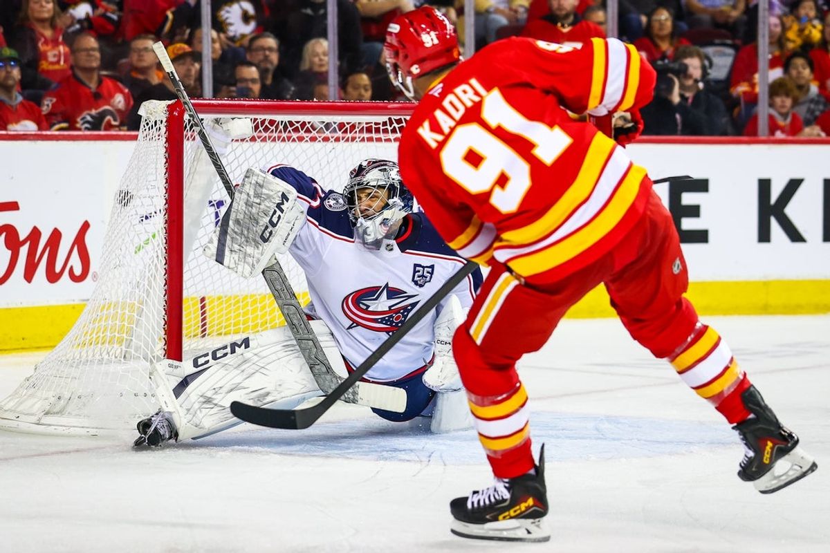 Nov 5, 2025; Calgary, Alberta, CAN; Calgary Flames center Nazem Kadri (91) scores a goal against Columbus Blue Jackets goaltender Jet Greaves (73) during the second period at Scotiabank Saddledome. Mandatory Credit: Sergei Belski-Imagn Images