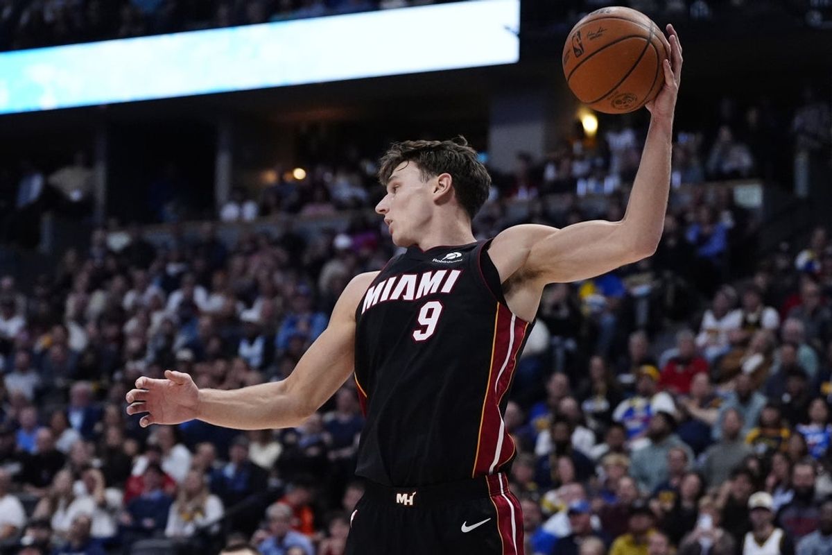 Nov 5, 2025; Denver, Colorado, USA; Miami Heat guard Pelle Larsson (9) grab the ball in the second quarter against the Miami Heat at Ball Arena. Mandatory Credit: Ron Chenoy-Imagn Images