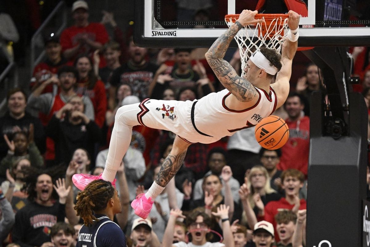 Nov 6, 2025; Louisville, Kentucky, USA;  Louisville Cardinals forward Kasean Pryor (7) dunks against Jackson State Tigers forward Jayme Mitchell Jr. (3) during the first half at KFC Yum! Center. Mandatory Credit: Jamie Rhodes-Imagn Images