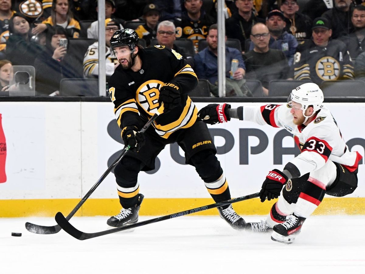 Nov 6, 2025; Boston, Massachusetts, USA; Boston Bruins center Mark Kastelic (47) attempts a shot against Ottawa Senators defenseman Nikolas Matinpalo (33) during the first period at the TD Garden. Mandatory Credit: Brian Fluharty-Imagn Images