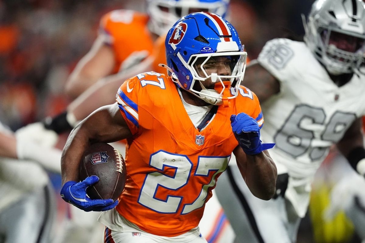 Nov 6, 2025; Denver, Colorado, USA; Denver Broncos running back J.K. Dobbins (27) rushes the ball against the Las Vegas Raiders during the first half at Empower Field at Mile High. Mandatory Credit: Ron Chenoy-Imagn Images