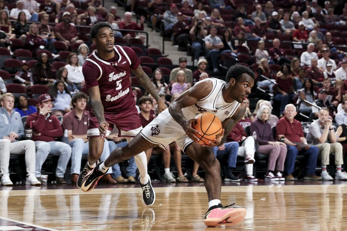 Nov 6, 2025; College Station, Texas, USA; Texas A&M Aggies guard Jacari Lane (5) drives as Texas Southern Tigers guard Jaylen Wysinger (5) defends during the first half at Reed Arena. Mandatory Credit: Maria Lysaker-Imagn Images