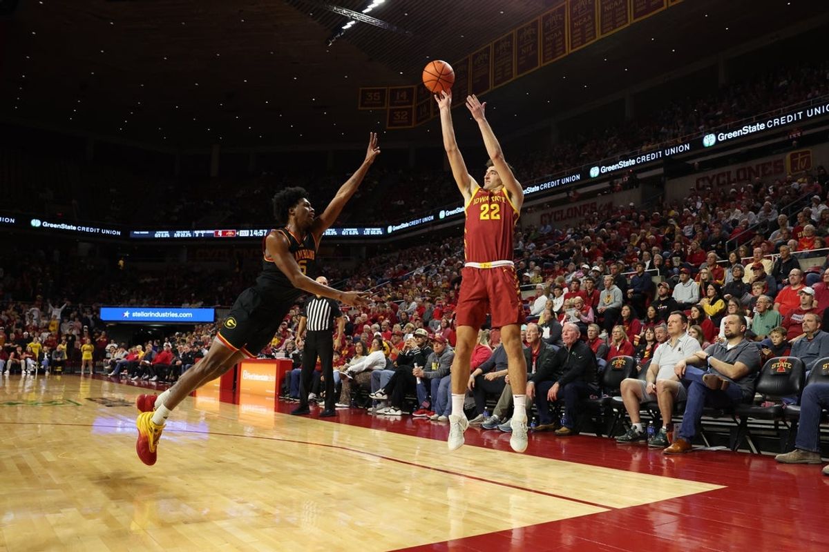 Nov 6, 2025; Ames, Iowa, USA; Iowa State Cyclones forward Milan Momcilovic (22) shoots over Grambling State Tigers Jimel Lee (5) during the first half at James H. Hilton Coliseum. Mandatory Credit: Reese Strickland-Imagn Images