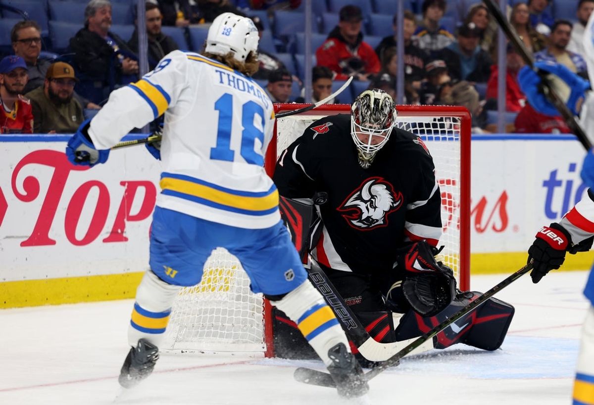 Nov 6, 2025; Buffalo, New York, USA;  Buffalo Sabres goaltender Ukko-Pekka Luukkonen (1) makes a save on St. Louis Blues center Robert Thomas (18) during the third period at KeyBank Center. Mandatory Credit: Timothy T. Ludwig-Imagn Images