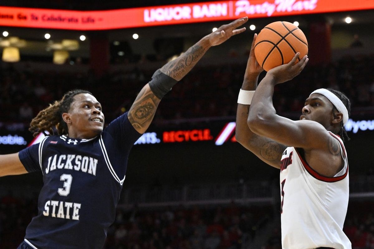 Nov 6, 2025; Louisville, Kentucky, USA;  Louisville Cardinals guard Ryan Conwell (3) shoots against Jackson State Tigers forward Jayme Mitchell Jr. (3) during the second half at KFC Yum! Center. Louisville defeated Jackson State 106-70. Mandatory Credit: Jamie Rhodes-Imagn Images