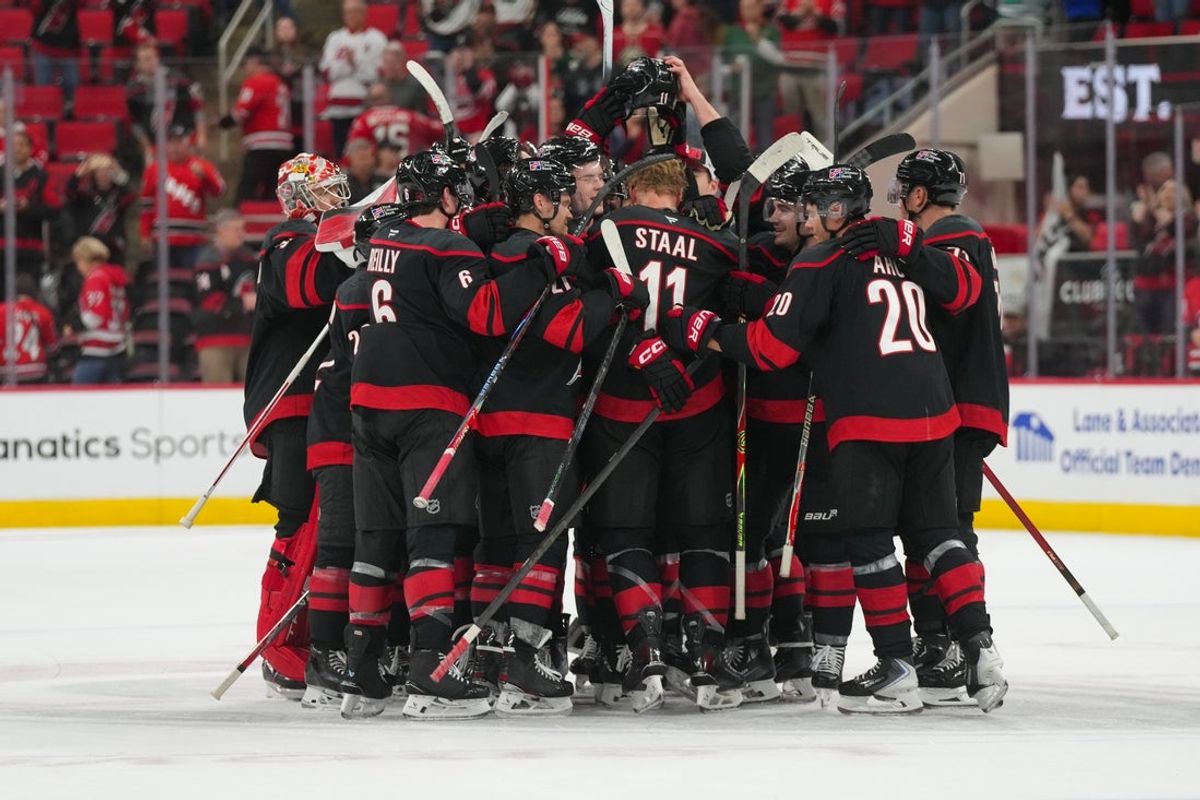 Nov 6, 2025; Raleigh, North Carolina, USA;  Carolina Hurricanes players celebrate their victory against the Minnesota Wild at Lenovo Center. Mandatory Credit: James Guillory-Imagn Images