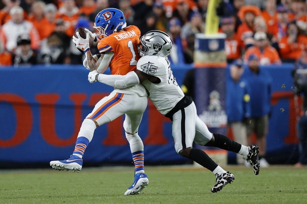 Nov 6, 2025; Denver, Colorado, USA; Denver Broncos tight end Evan Engram (1) makes a catch over Las Vegas Raiders linebacker Devin White (45) during the first half at Empower Field at Mile High. Mandatory Credit: Isaiah J. Downing-Imagn Images