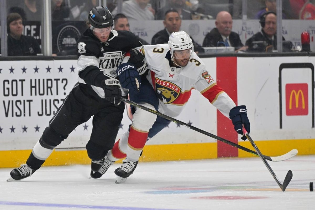 Nov 6, 2025; Los Angeles, California, USA; Los Angeles Kings right wing Adrian Kempe (9) and Florida Panthers defenseman Seth Jones (3) battle for the puck during the second period at Crypto.com Arena. Mandatory Credit: Jayne Kamin-Oncea-Imagn Images