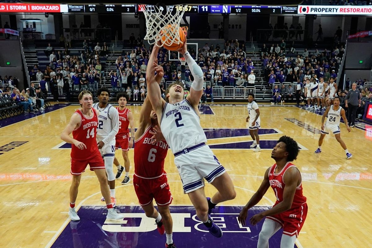 Nov 7, 2025; Evanston, Illinois, USA;  Northwestern Wildcats forward Nick Martinelli (2) shoots the ball against Boston University Terriers guard Sam Hughes (6) (obscured) during the first half at Welsh-Ryan Arena. Mandatory Credit: David Banks-Imagn Images