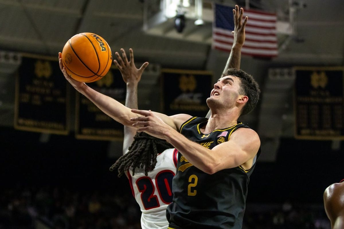 Nov 7, 2025; South Bend, Indiana, USA; Notre Dame Fighting Irish guard Logan Imes (2) drives past Detroit Mercy Titans forward London Maiden (20) during the first half at Purcell Pavilion at the Joyce Center. Mandatory Credit: Michael Caterina-Imagn Images