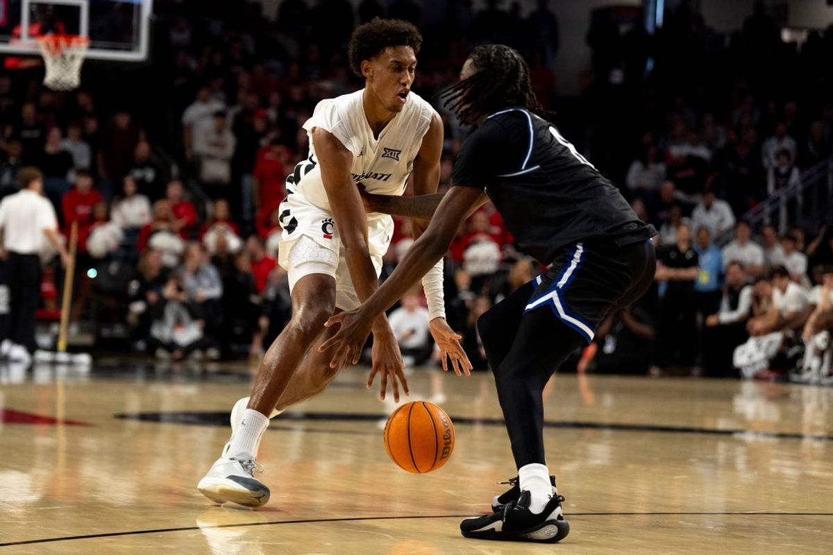 Cincinnati Bearcats forward Baba Miller (18) dribbles around Georgia State Panthers forward Joah Chappelle (6) in the first half of the NCAA basketball game at Fifth Third Arena in Cincinnati on Nov. 7, 2025.