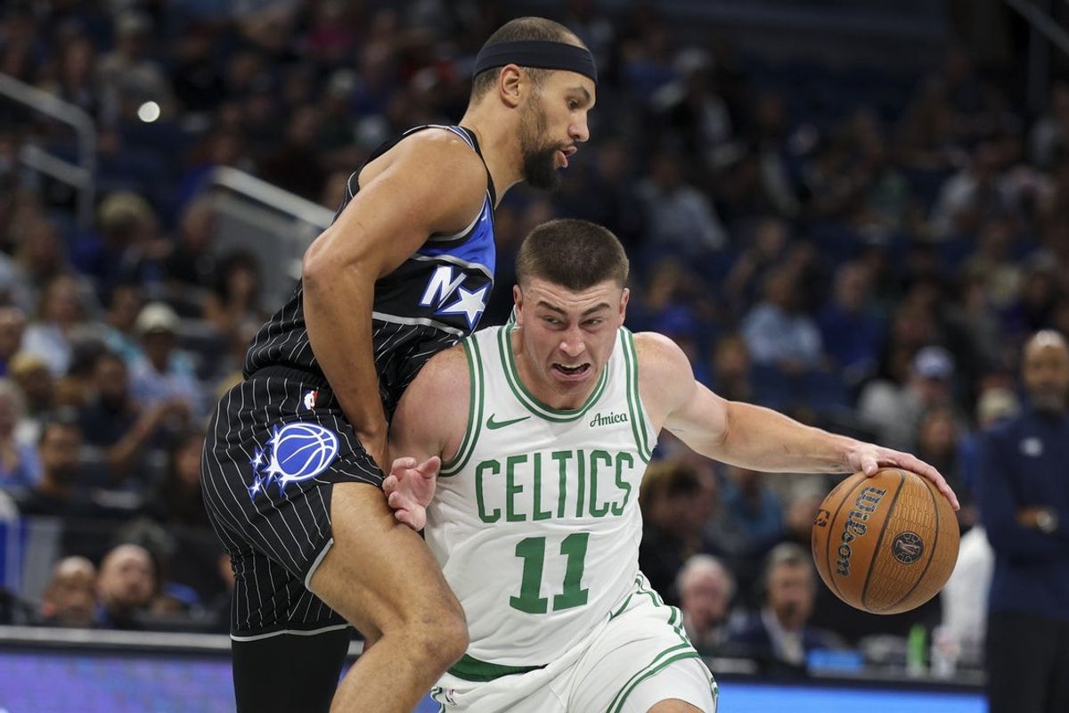 Nov 7, 2025; Orlando, Florida, USA; Boston Celtics guard Payton Pritchard (11) drives to the basket past Orlando Magic guard Jalen Suggs (4) in the first quarter at Kia Center. Mandatory Credit: Nathan Ray Seebeck-Imagn Images