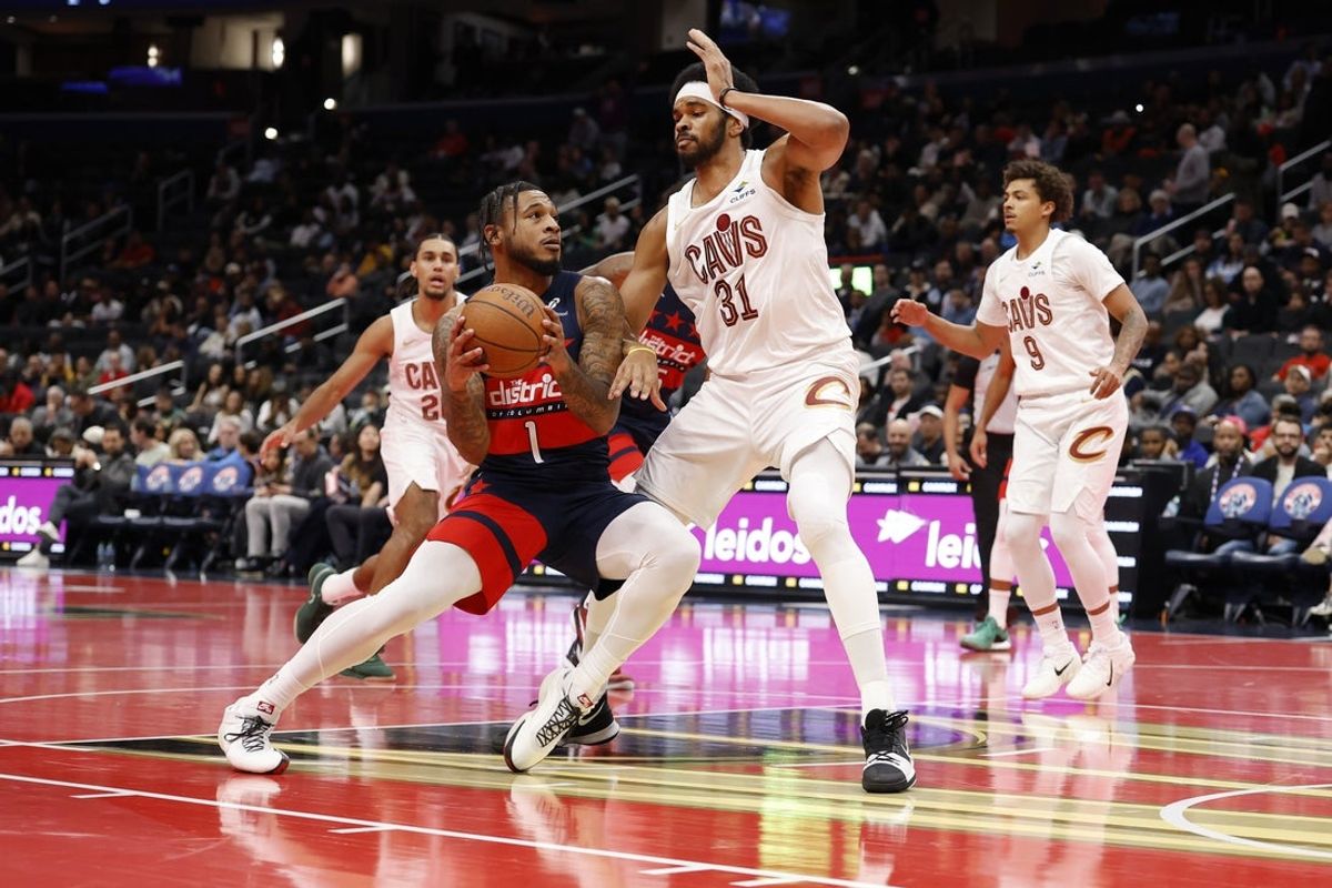 Nov 7, 2025; Washington, District of Columbia, USA; Washington Wizards forward Cam Whitmore (1) drives to the basket as Cleveland Cavaliers center Jarrett Allen (31) in the first half in an Emirates NBA Cup game at Capital One Arena. Mandatory Credit: Geoff Burke-Imagn Images