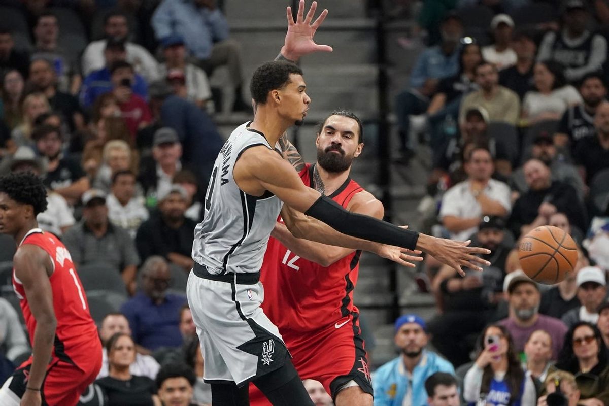 Nov 7, 2025; San Antonio, Texas, USA;  San Antonio Spurs forward Victor Wembanyama (1) passes against Houston Rockets center Steve Adams (12) during the second quarter at Frost Bank Center. Mandatory Credit: Dustin Safranek-Imagn Images